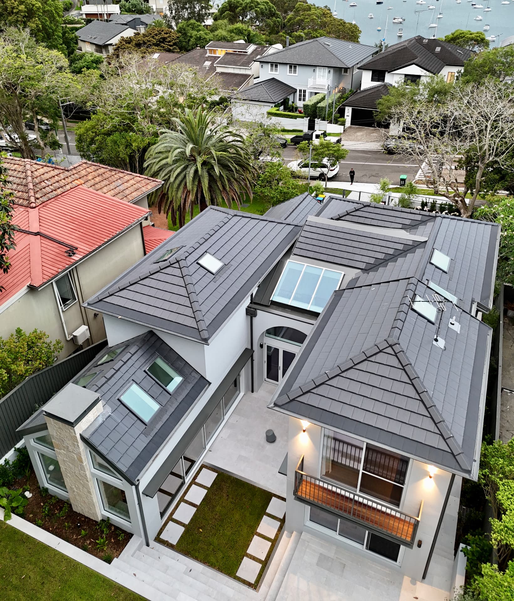 Aerial view of a modern home with a grey tiled roof completed by Marvel Roofing Projects in Sydney
